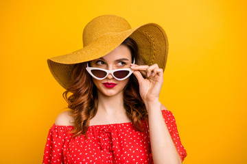 Angry lady look window dislike rainy weather wear red dress sun specs and hat isolated yellow background