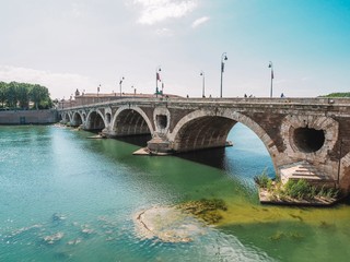 Bridge in Toulouse, France. Green water