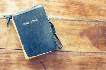Holy Bible isolated on old vintage wooden table