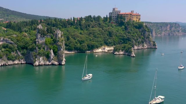 Sea shore near Trieste, Italy. Aerial drone view of ruines of the old fortress of Duino Castle.