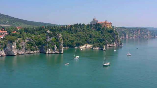 Sea shore near Trieste, Italy. Aerial drone view of ruines of the old fortress of Duino Castle.