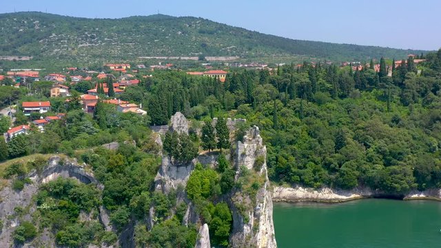 Sea shore near Trieste, Italy. Aerial drone view of ruines of the old fortress of Duino Castle.