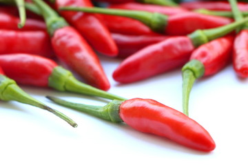 close up red chillies pile on white background