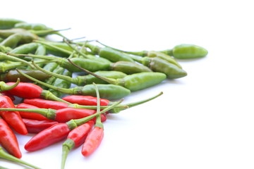 Group of green and red chillies pile on white background, have space