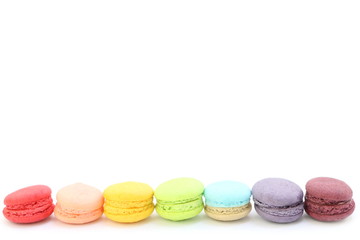 Line of colorful fresh sweet cake macaroons on the white background, have copy space for put text. rainbow color.