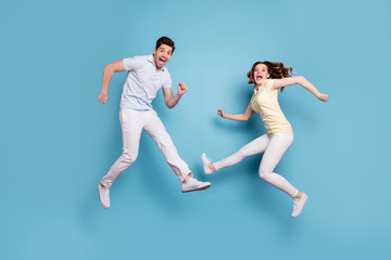 Full length body size view of nice-looking attractive lovely playful childish carefree cheerful cheery people having fun fooling rejoicing isolated over bright vivid shine blue green background