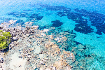 Aerial view of beautiful rocky coastline with turquoise sea water..