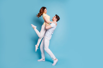 Full length body size profile side view of nice-looking attractive cheerful cheery spouses wearing casual having fun dancing isolated over bright vivid shine blue green background
