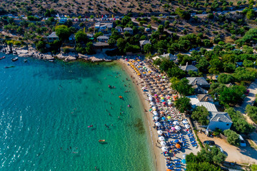 Fototapeta premium Aerial View of the Aliki Beach with colorful umbrellas, at Thassos island, Greece