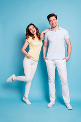 Fototapeta premium Vertical full length body size view of nice-looking attractive lovely cheerful cheery glad married spouses having fun time isolated over bright vivid shine blue green background