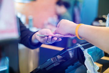 Cashier take banknote from consumer hand. Hand Paying Money To Worker In Coffee shop. Saleswoman...