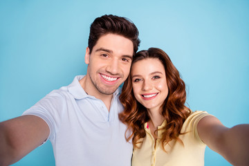 Close up photo of foxy lady brunet guy pair making selfies toothy beaming smile wear casual t-shirts isolated blue background