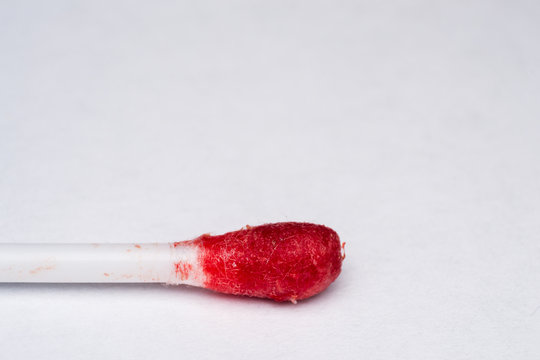 cotton bud with blood on his surface close-up