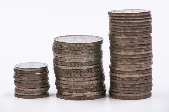 Stack of coin with alphabet block witten with tax related such as gst, sst and vat