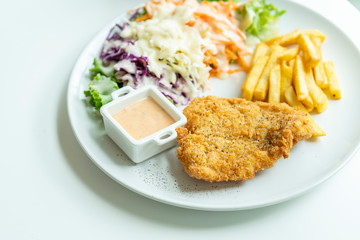 Fried fish steak on white