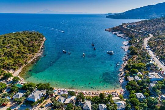 Aerial View of the Aliki Beach with colorful umbrellas, at Thassos island, Greece