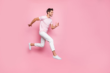 Fototapeta na wymiar Full size profile side photo of attractive person running smiling isolated over pink background