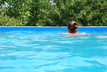 Girl Swimming in Pool Portrait