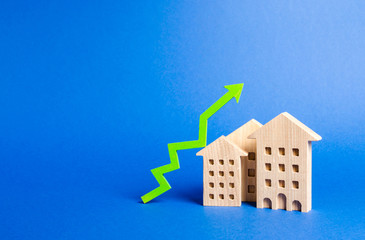 figures of residential buildings and green arrow up. Growth in demand and liquidity for real...