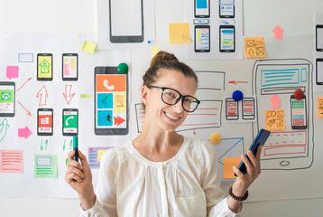 Mobile app designer. Woman specialist in the development of programs for smartphones.