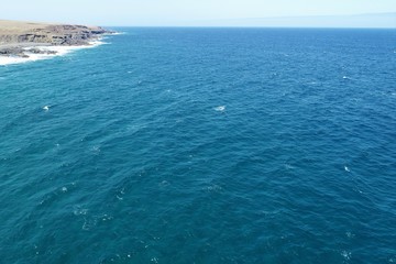 dawn between desert mountains and cliffs almost without vegetation with the Atlantic Ocean imposing