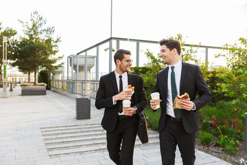 Two attractive young businessmen wearing suits