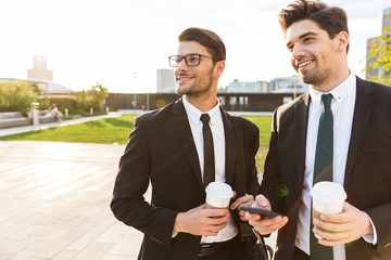 Two attractive young businessmen wearing suits