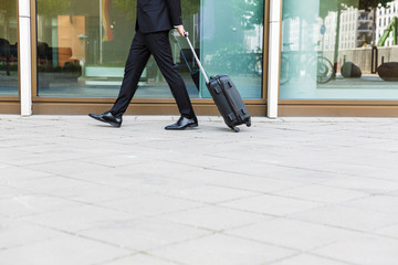 Cropped image of a businessman wearing suit walking