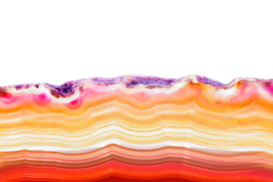 Abstract background, orange and red agate striped mineral cross section isolated on white background