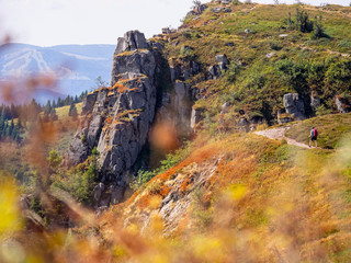 Rear view of women hiking up over rocky mountain of Vosges at Gazon du Faing, France