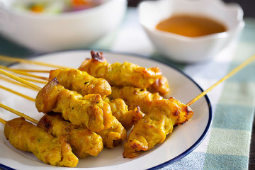 Pork Satay with peanut sauce and vegetables salad sauce on napery cloth