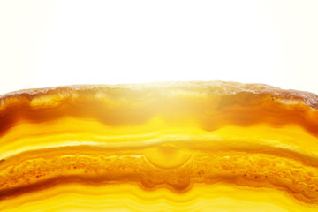 Abstract background, brown and orange striped agate slice mineral cross section with sunset spot on white background