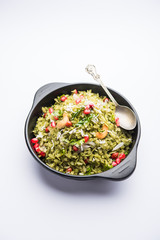 Hariyali Poha / Green Masala Pohe or flattened rice served in a bowl, selective focus