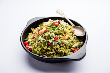 Hariyali Poha / Green Masala Pohe or flattened rice served in a bowl, selective focus