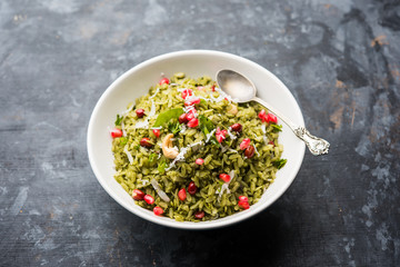 Hariyali Poha / Green Masala Pohe or flattened rice served in a bowl, selective focus