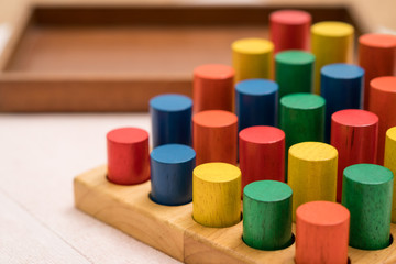 Closeup of colorful wooden Montessori sensorial material learning, Sizing and order block. Kindergarten educational toys, Thinking process, Cognitive skills, Learn Through Play tools concept.