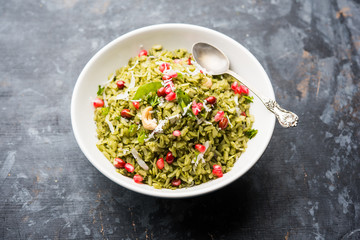 Hariyali Poha / Green Masala Pohe or flattened rice served in a bowl, selective focus