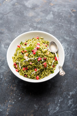 Hariyali Poha / Green Masala Pohe or flattened rice served in a bowl, selective focus