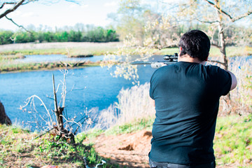 Hunter in the woods by a river