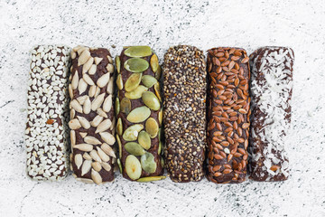 Chocolate energy protein bars with nuts, seeds, dry fruits. Healthy dietary snack. Vegan dessert. Chia, flax seeds, coconut, sesame, pumpkin, sunflower seeds.
