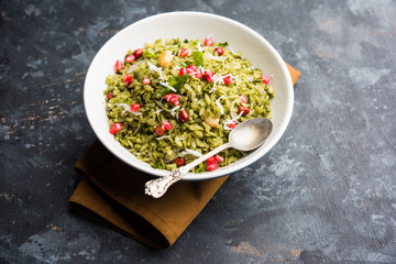 Hariyali Poha / Green Masala Pohe or flattened rice served in a bowl, selective focus