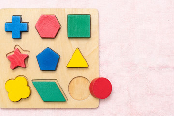 Top view closeup of colorful wooden Montessori sensorial material learning, Shape and color block. Kindergarten educational toys, Thinking process, Cognitive skills, Learn Through Play tools concept.