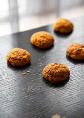 homemade carrot scones on a dark wooden backdrop, dark style