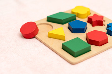 Top view closeup of colorful wooden Montessori sensorial material learning, Shape and color block....