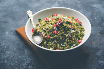 Hariyali Poha / Green Masala Pohe or flattened rice served in a bowl, selective focus