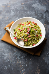 Hariyali Poha / Green Masala Pohe or flattened rice served in a bowl, selective focus