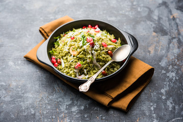 Hariyali Poha / Green Masala Pohe or flattened rice served in a bowl, selective focus