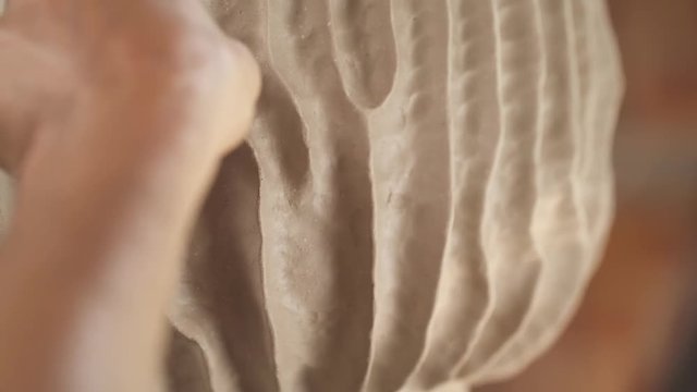Close-up demonstration video of potters hands crafting the clay pot. Artist working in workshop. Modern art concept. Unique handmade product creation