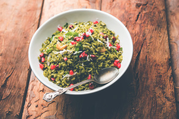 Hariyali Poha / Green Masala Pohe or flattened rice served in a bowl, selective focus
