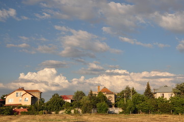 Houses against a blue cloudy sky